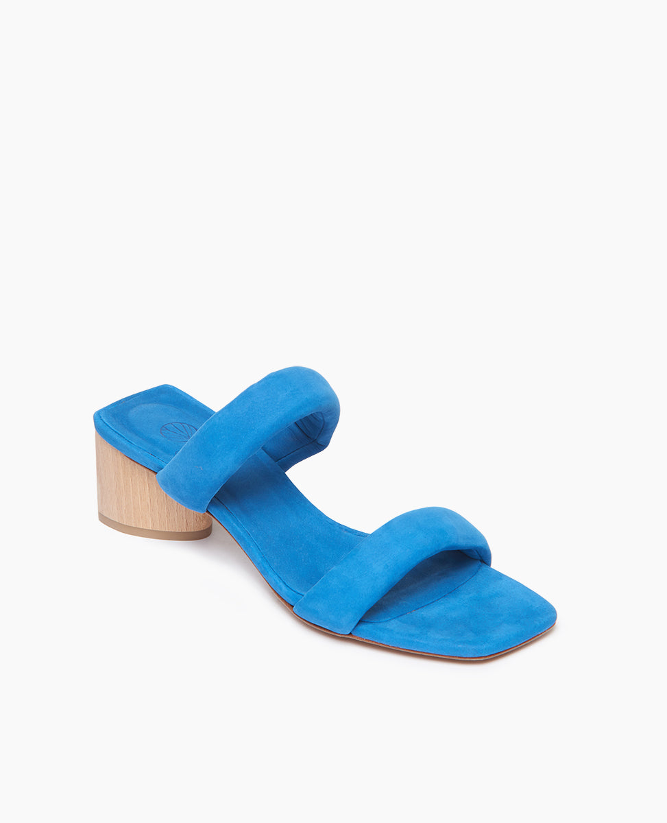 Coclico Sofiya Heel in Blu Reale nubuck, angle view: a slide-on sandal with two padded leather straps across foot, angular toe and heel design, low-height solid wood triangular heel.