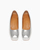 Front view of the Trinity Pump in Milky Way leather ; featuring a classic pump silhouette with a artfully formed squared and a leather covered wood platform. 4