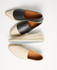 Artfully arrranged pairs of the Udo sneaker showing the teal sole. 5