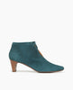 Coclico Waffles Boot in Bottle suede, side view: the perfect dress-up bootie featuring a 50mm softly arched solid wood heel, gathered tie at the ankle which reveals top of the foot and a pointed toe. 1