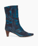 Side view of the Wakame Boot in Painter's Blue split suede: a sophisticated snip-point-toe boot with an arched wood heel.  Inside zip closure.  1