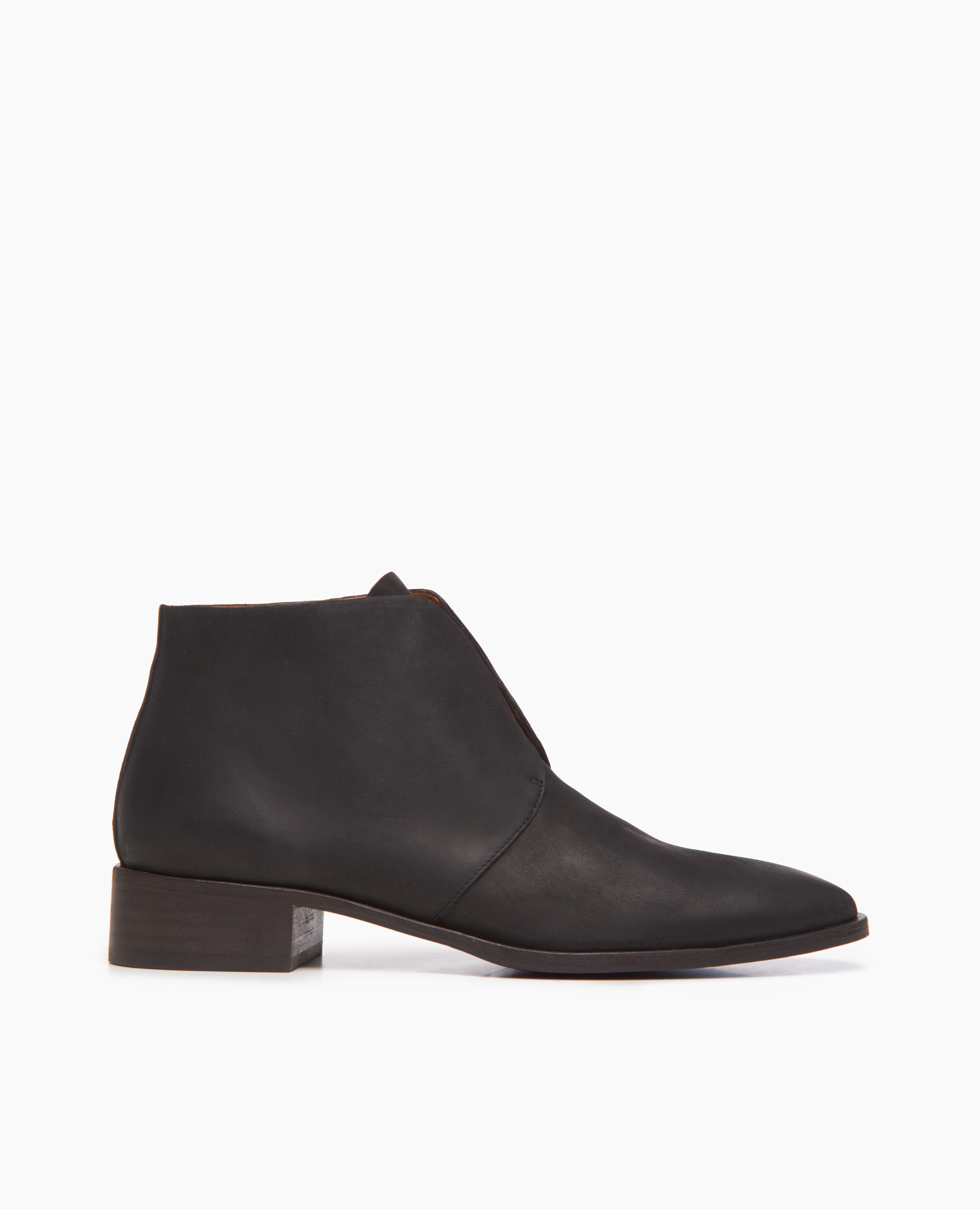 Side view of the Midori Bootie in black; featuring a sleek, lace-free Derby bootie with raw edge finishing. Leather sole.
