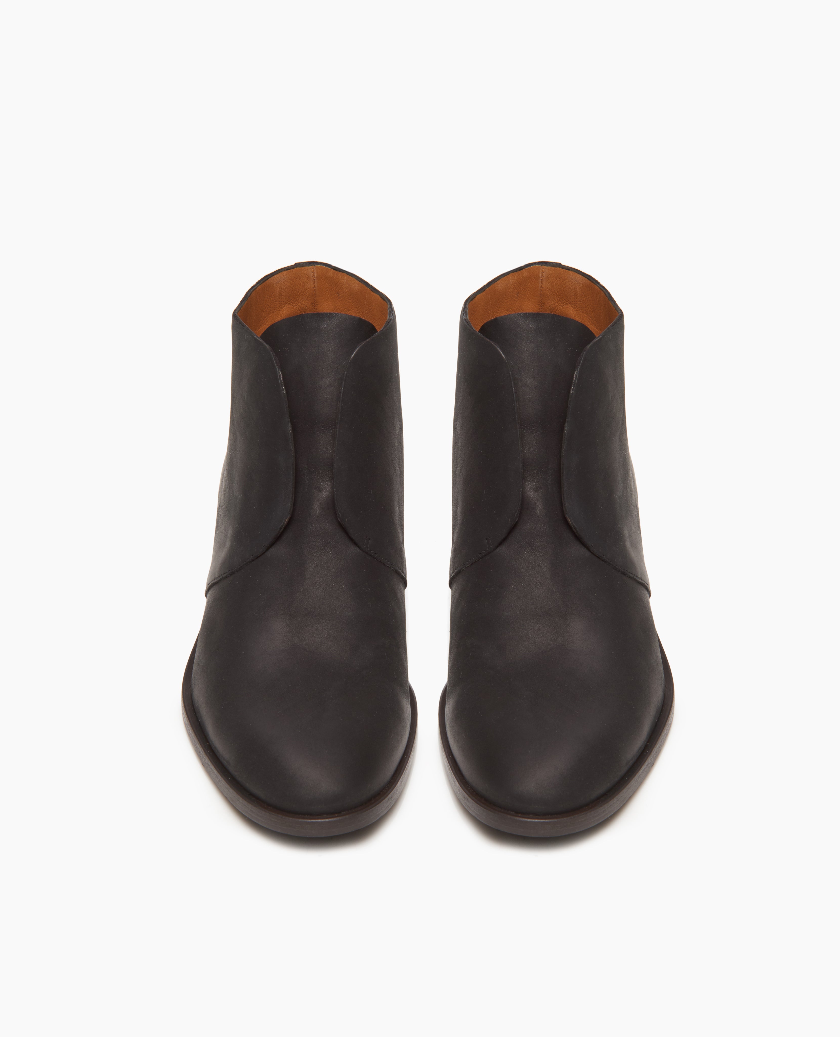 Front view of the Midori Bootie in black; featuring a sleek, lace-free Derby bootie with raw edge finishing. Leather sole.