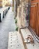 The Bita Heel in Grey Mist on the stone steps of a building in France. 5