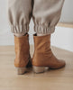 Close up of Coclico Caviar Boots low-height wood block heel - on wood flooring. 4