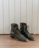 Pair of the Coclico Jewel Boot in Boscu leather placed on wood flooring to show off its squared-off toe and inside zip closure - angle view. 3