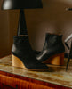 Lodi Boot in Black leather - close of Coclico boot on marble table. 6