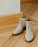 Sake Boot in Siberia (cream) cord suede: Sunlit, angle view of a Coclico lace-up boot with a 40mm solid wood block heel and rounded toe. 5