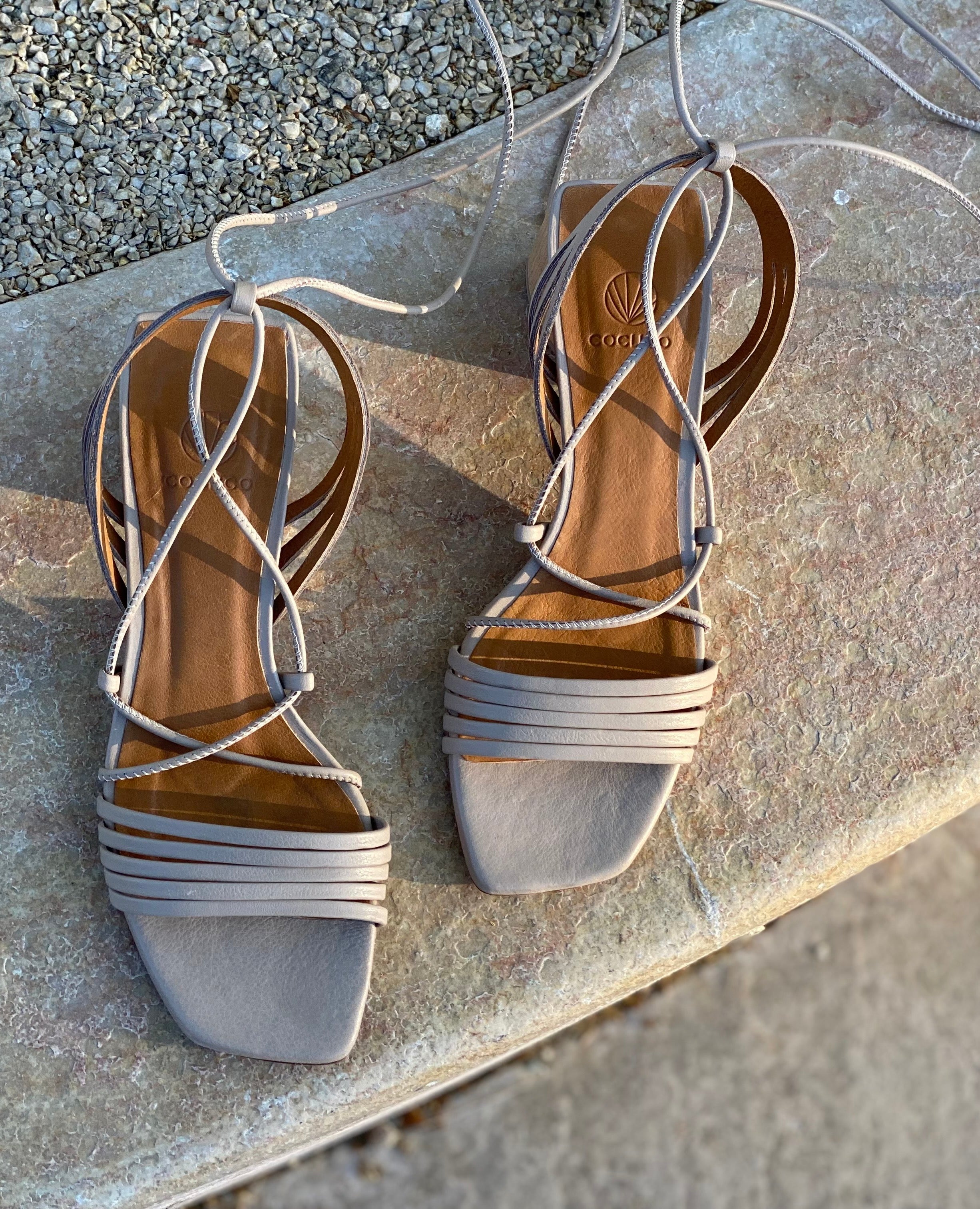 Top view of the Solomiya heel on a curved stone wall.