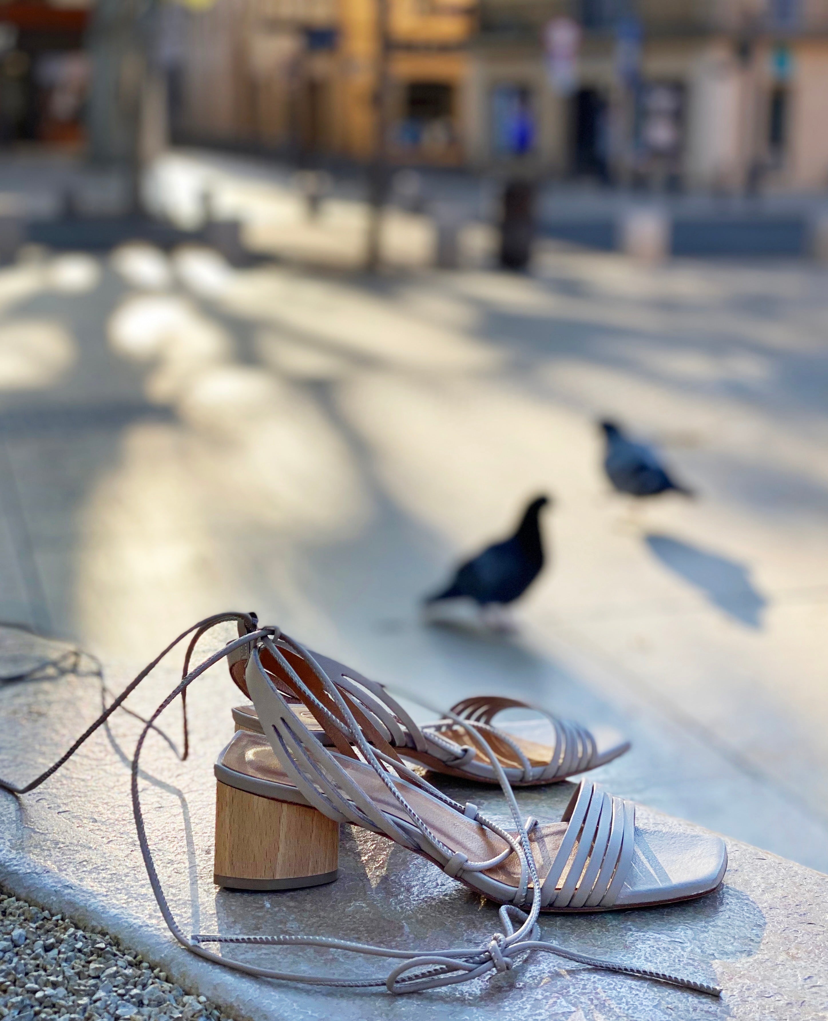 Side view of the Solomiya heel on a curved stone wall.