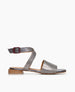 Coclico women's flat ankle strap sandal in a pewter snake embossed leather with a a red buckle. Coclico shoes are sustainably made in Spain. 1