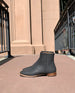Sunlit side view of Coclico Egg Boot in Black Caviar textured leather.  4