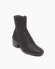 Coclico Franna Boot in Black leather, a mid-height solid wood block black heel, stepped topline, squared-off toe, scored rubber sole and an inside zip closure - angle view. 2