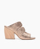Coclico women's glamorous yet classic slide with metallic blush leather upper and a sculpted wood heel. Coclico shoes are sustainably made in Spain. 1