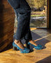 Legs of a woman in blue corduroy pants wearing the Trinity Pump in Painter's Blue.  6