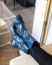 Lower legs of a woman wearing the Wakame Boot in Painter's Blue.  6