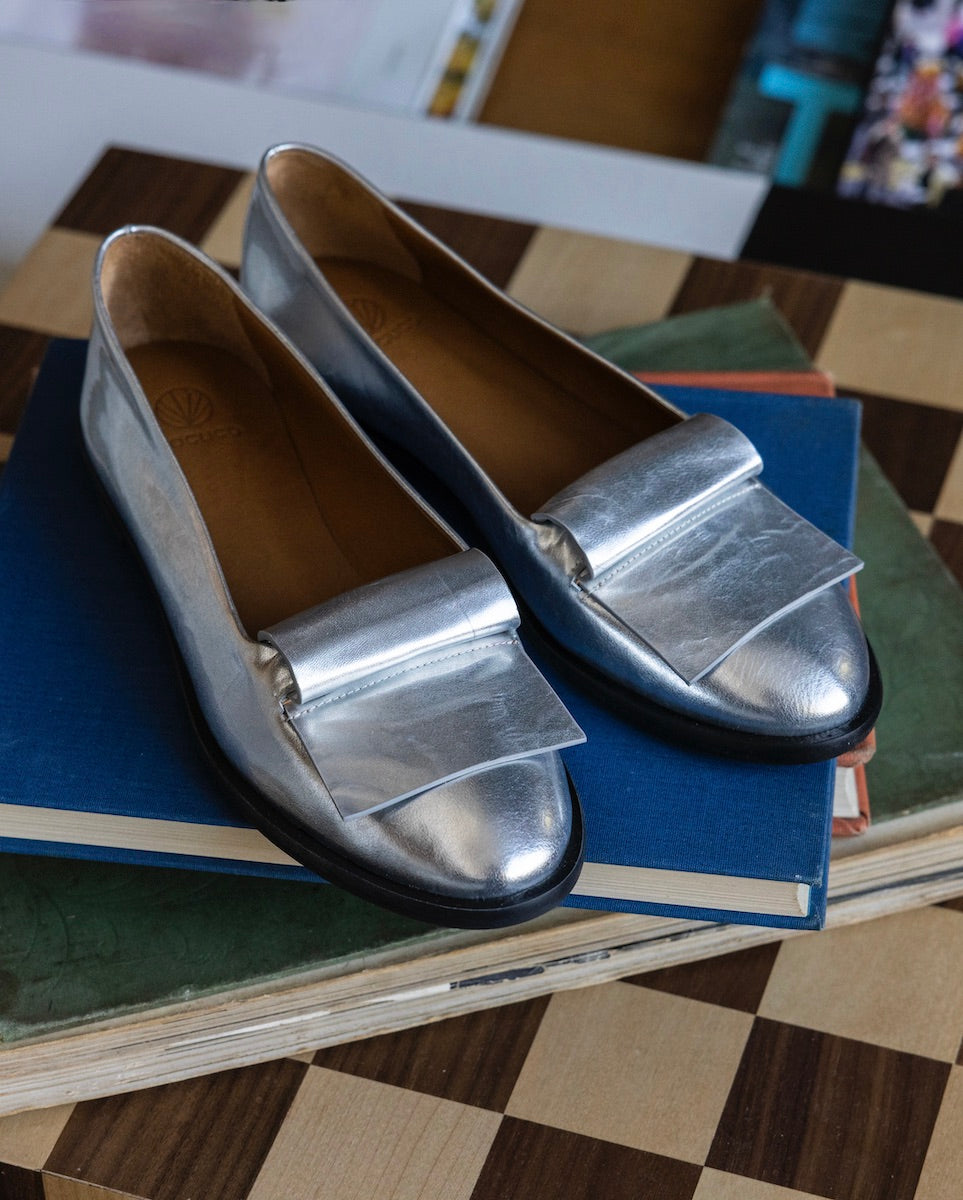 Yale Loafer in Milky Way placed on top of books.
