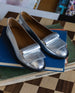 Yale Loafer in Milky Way placed on top of books.  4
