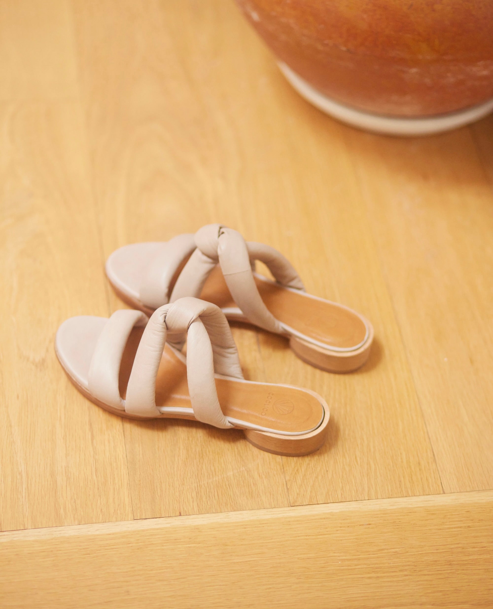 Close up of Coclico Everly Sandal in Grey Mist leather: open sandal with padded straps in a twist across the arch, raised two-part leather sole - top/angle view.