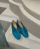 Coclico Harissa Flat placed on pillar showing off the Bottle suede. 5