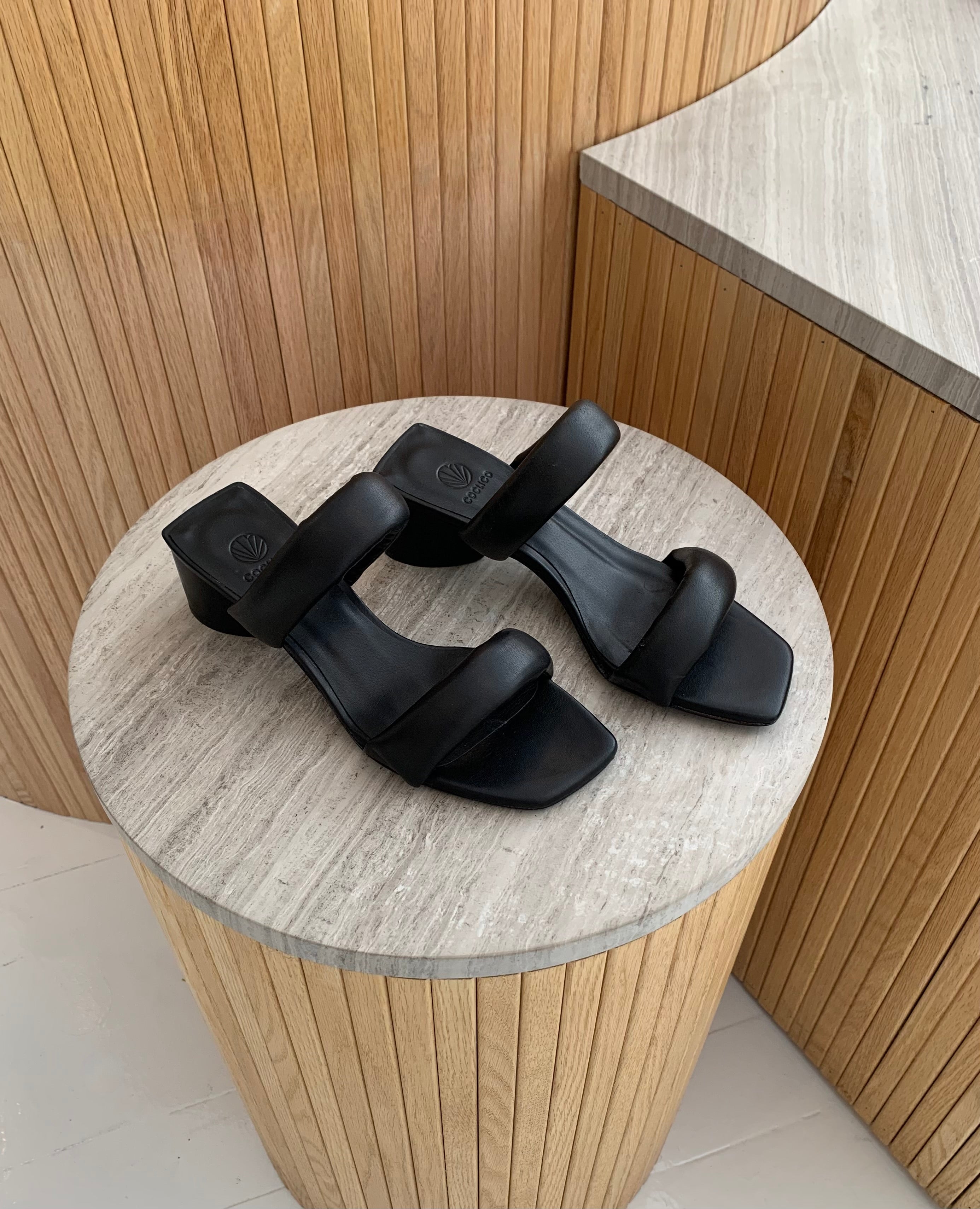 top view of Mid-heel all black slide sandal with two padded straps across the foot.