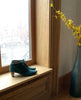 Sunlit, side view of the Coclico Waffles Boot in Bottle suede on window sill. 4