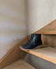 Side view Java Boot in Black placed on a wooden step. 4