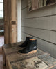 Left view of the Java Boot in Black placed on a wooden trunk. 7
