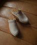 Close up of the Coclico Milk Clog in Limestone nubuck - on leather couch.  8