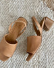 Close up, top view of Coclico Okolo Sandal in Mandorla leather: a slingback sandal with a wide stretch leather band across the foot and a softly curved, low, solid walnut wood heel. 5