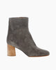 Side view: Coclico Pimiento Boot in Anthracite suede, the perfect boot that will take you from day to night featuring a seam ankle detailing, mid-height solid wood block heel and an inside zip closure. 1
