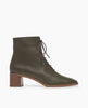 Side view of the Coclico Jewel Boot in Boscu leather, a glove leather lace-up with a squared-off toe, welted leather sole, mid-height solid wood block heel, inside zip closure. 1