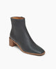 Coclico Juju Boot in Deep Sea (blue/black) leather, a minimalist boot featuring an inside zip closure, soft squared-off toe, mid-height solid wood block heel, mid-height shaft - angle view. 2