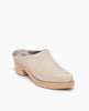 Angle view of the Coclico Kera Shearling Clog in Latte nubuck: a slip-on mule with a mid-height wood block base, tapered toe, shearling lining. 6