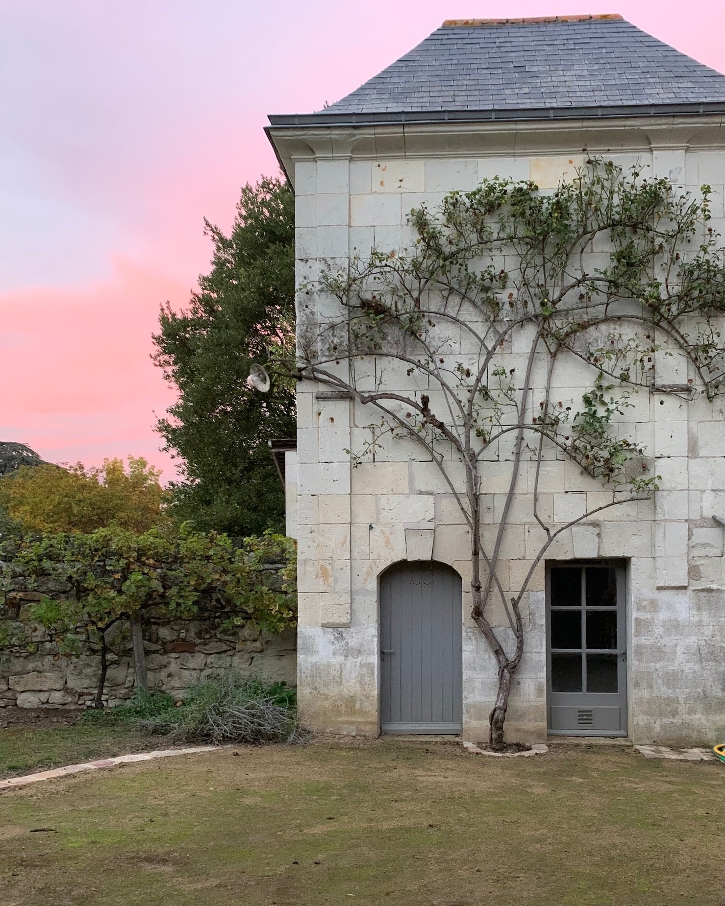 Stone building on an estate in France with sunset.