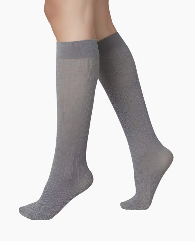 Knee-high, semi-sheer gray socks with a smooth texture and a subtle ribbed pattern, featuring a reinforced toe and heel for added durability.