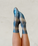 Metallic blue socks with a ribbed texture and a subtle gradient effect, featuring a snug fit and a soft, shiny material. 1