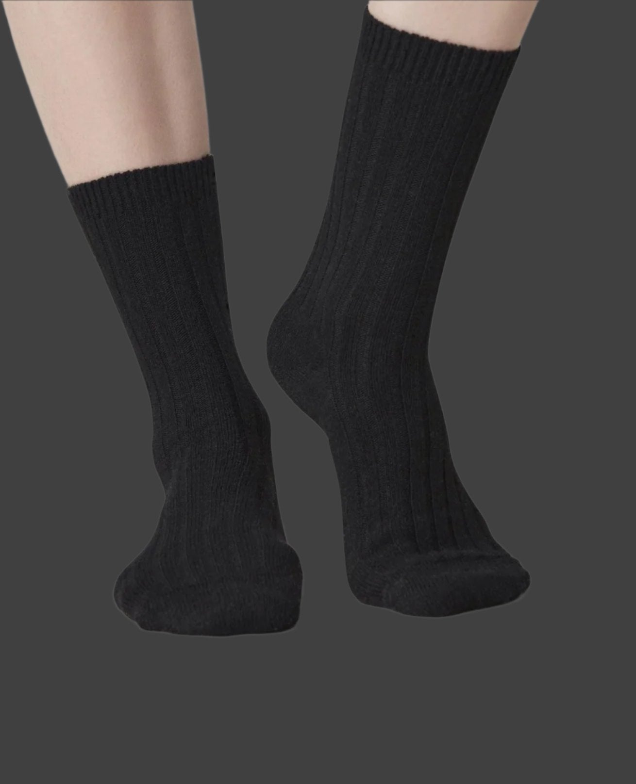 Swedish Stockings Bodil chunky knit wool socks shown worn on a model's foot from the calf down while they face forward.