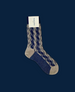 A single mid-calf sock featuring a zigzag pattern in navy blue and light gray, with a ribbed texture, made from a soft, stretchy fabric, and a label attached near the top. 1