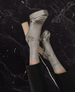 Legs on a marble wall wearing the Angle heel styled with socks 9