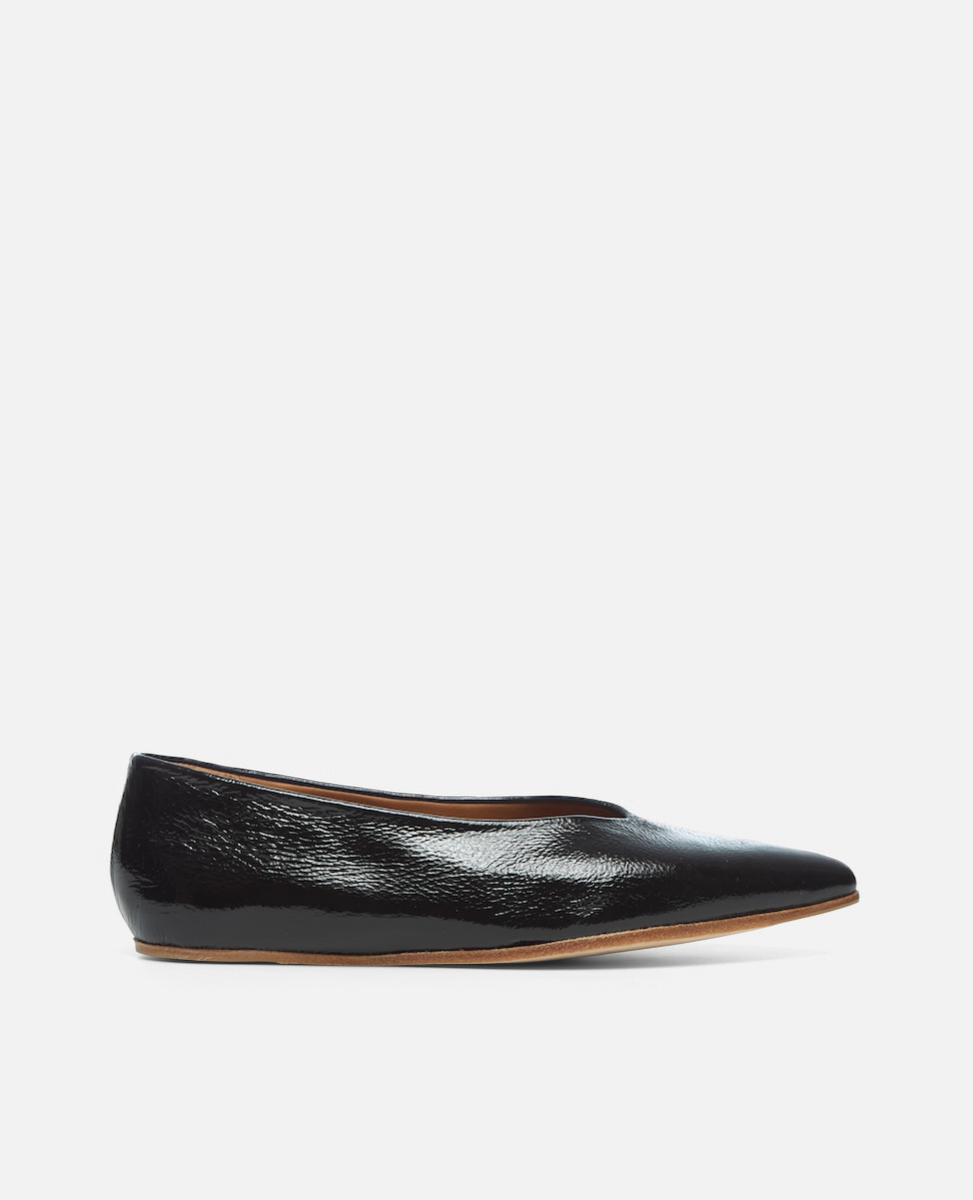 Black leather flat shoe on a white background