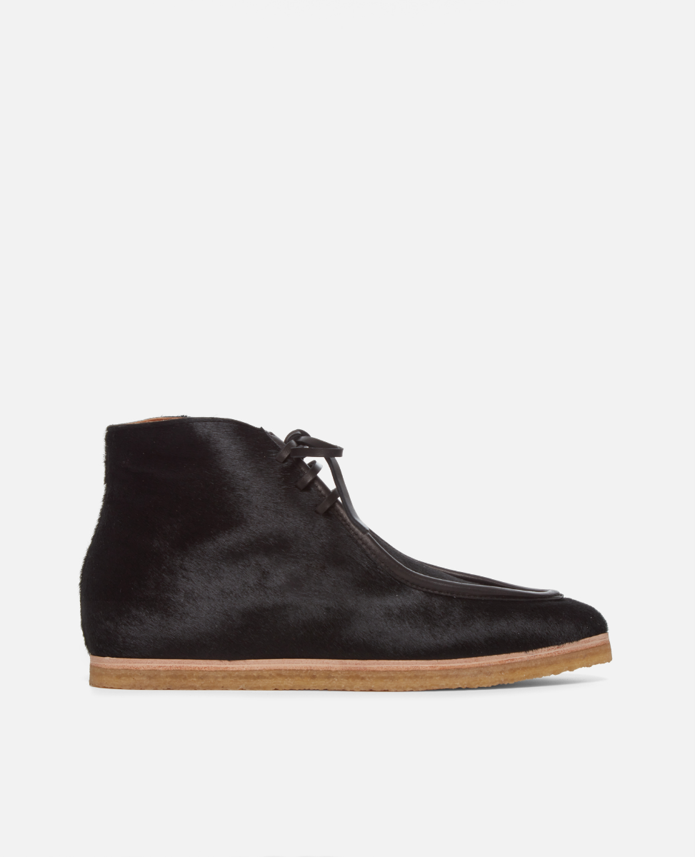 Black haircalf lace up shoe with crepe sole on a white background