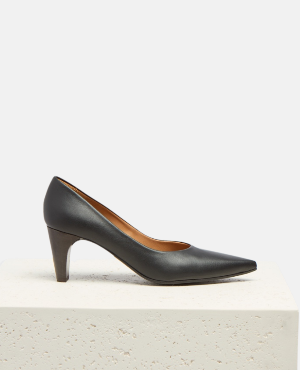 Black high-heeled shoe on a light gray background