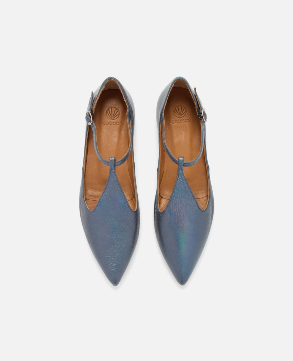 Pair of blue pointed-toe shoes with brown soles on a white background