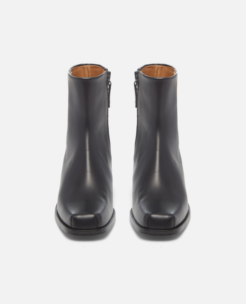 Pair of black ankle boots on a white background