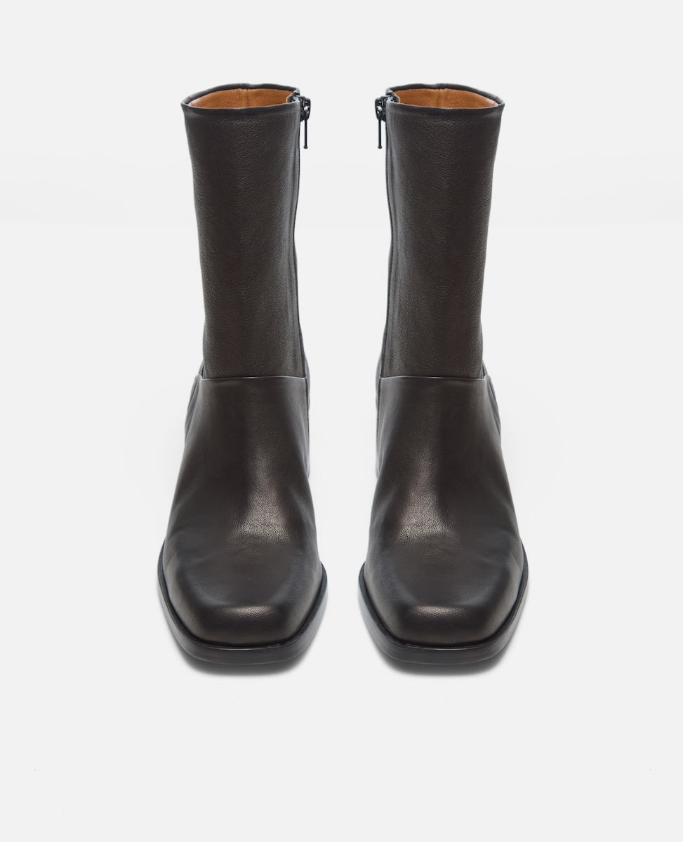 Pair of black leather boots on a white background