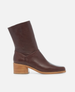 Brown leather ankle boot with a block heel on a white background 1