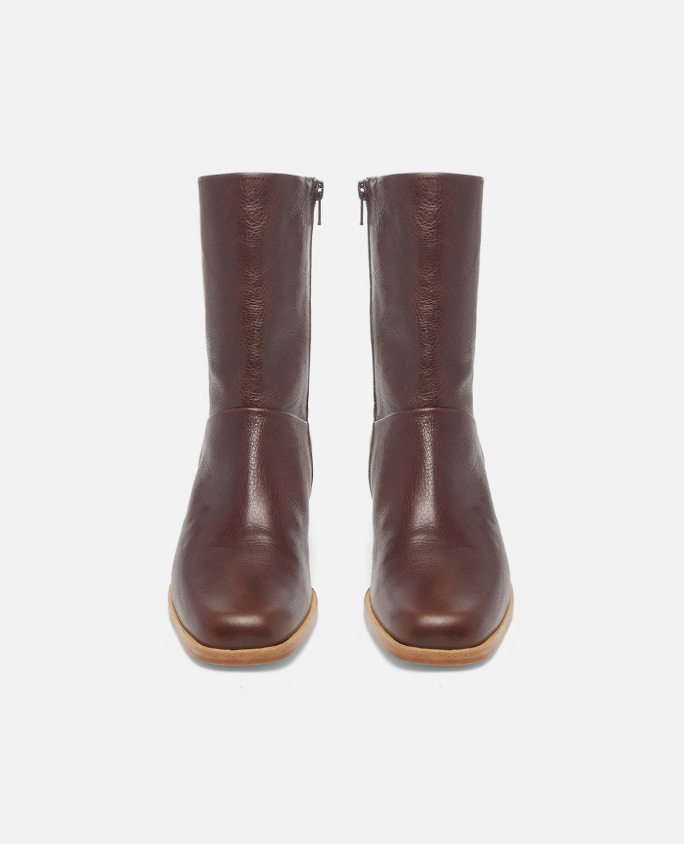 Pair of brown leather boots on a white background