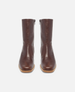 Pair of brown leather boots on a white background 3
