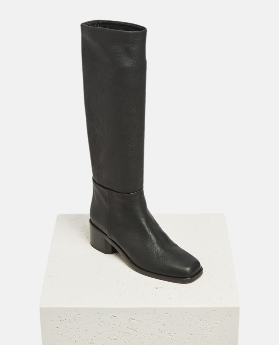 Black knee-high boot on a white background